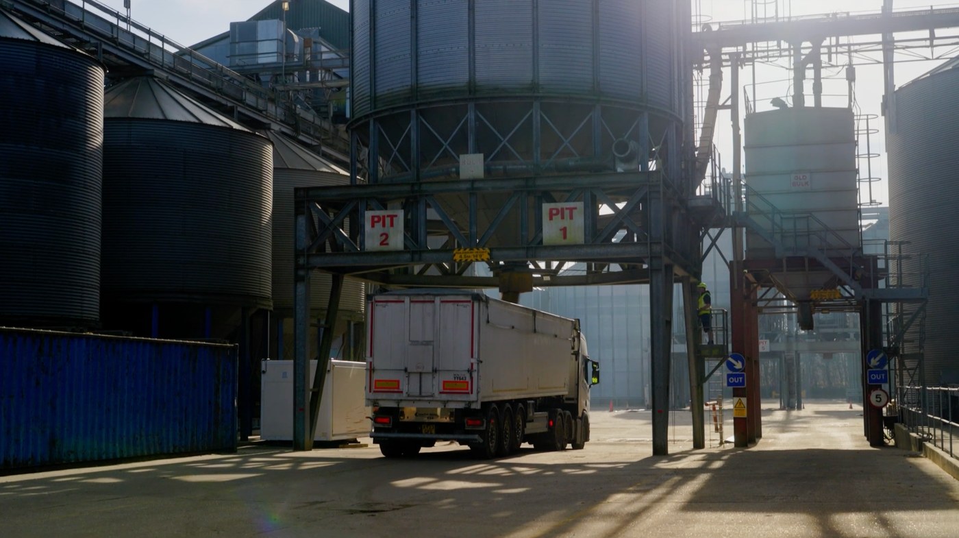 A lorry under the pits at a grain store, waiting to tip